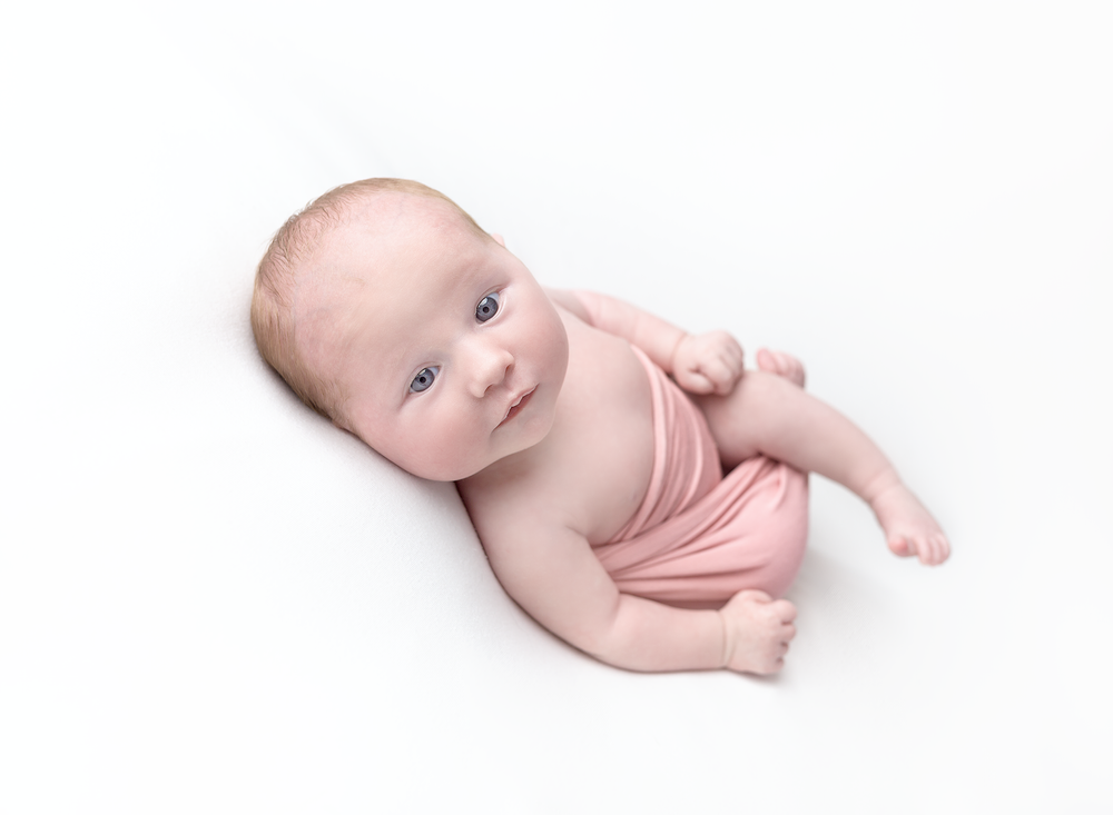 Beautiful baby girl in white and pink on white backdrop. Baby Photoshoot at Fairy Nuff Photography Nottingham