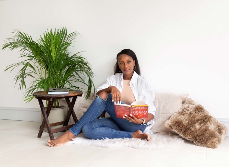Relaxed woman reading coaching books at a business branding photo session