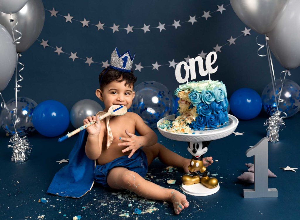 Blue and silver little prince set up with silver and blue balloons on a dark blue backdrop by Fairy Nuff Photography, Nottingham