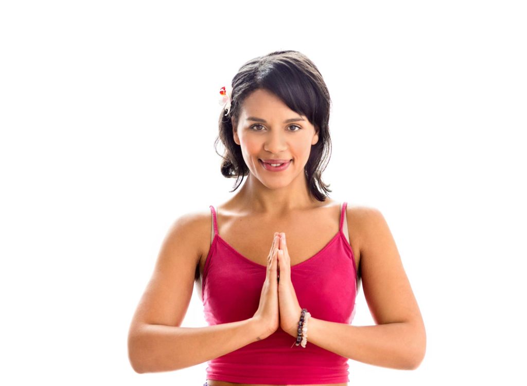 Yoga teacher in prayer has over heart pose against a white background in a business branding photography session