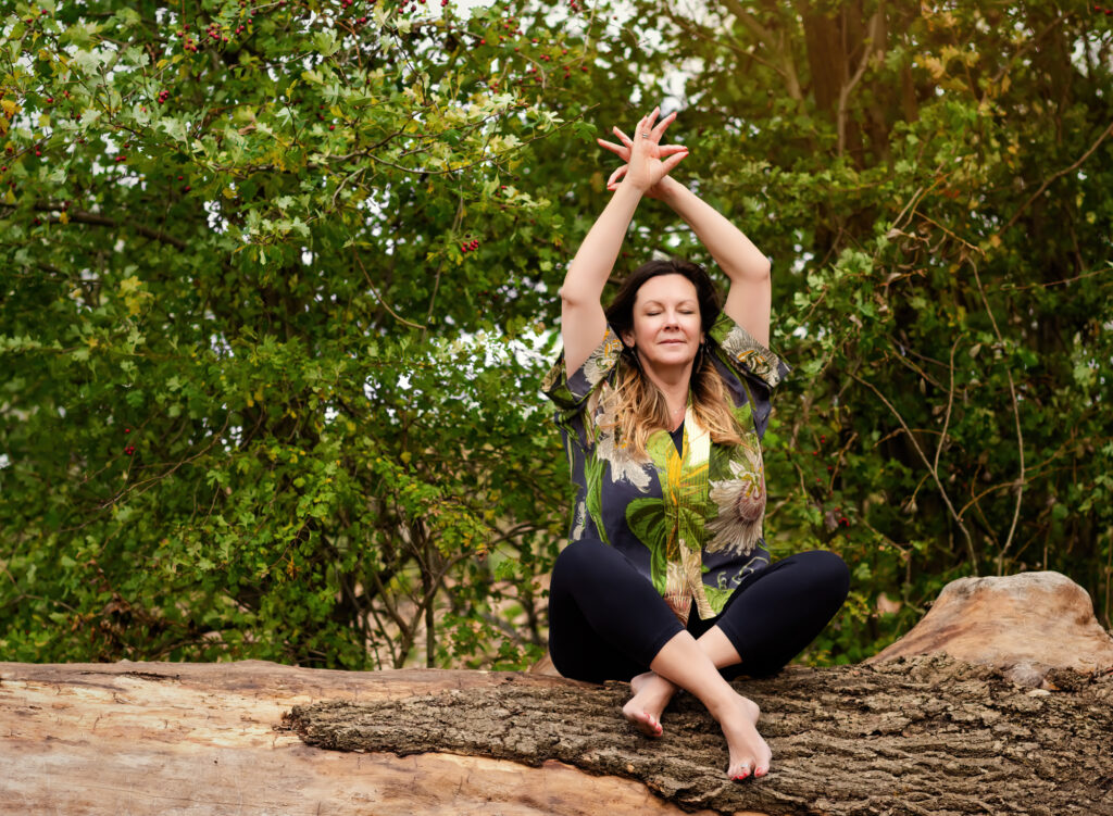 Business branding photography session by Fairy Nuff Photography, yoga teacher posed in a forest seated on a fallen log