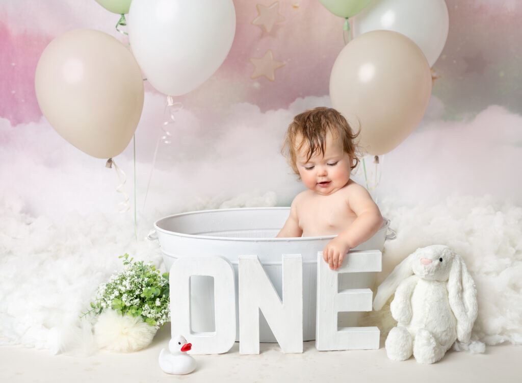 Bath time set up, with pink pastel balloons and backdrop and rubber ducks 1st Birthday photography session, Fairy Nuff Photography, Nottingham